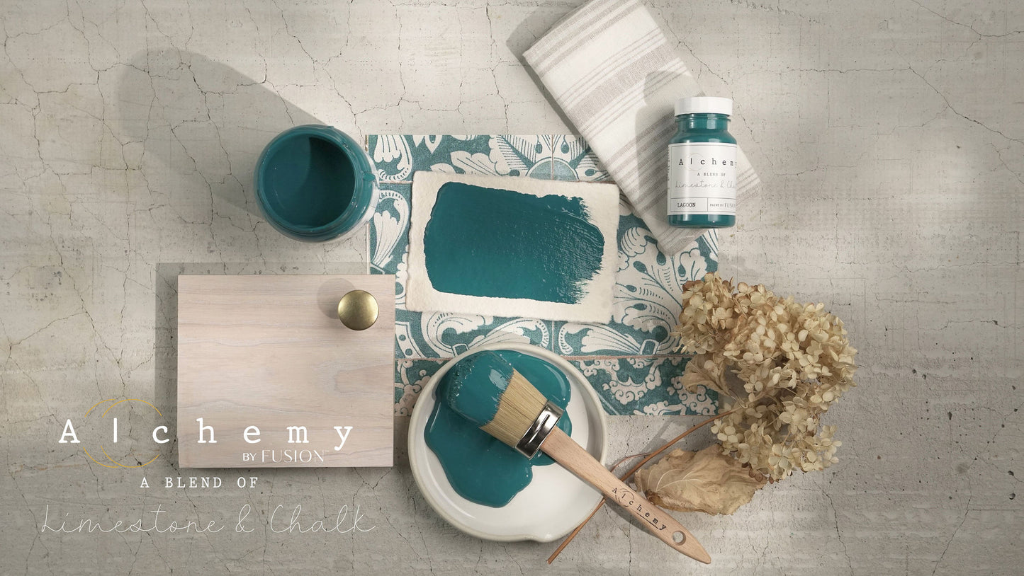 A jar of Alchemy by Fusion chalk paint in a lagoon color, which is a blend of green and blue.