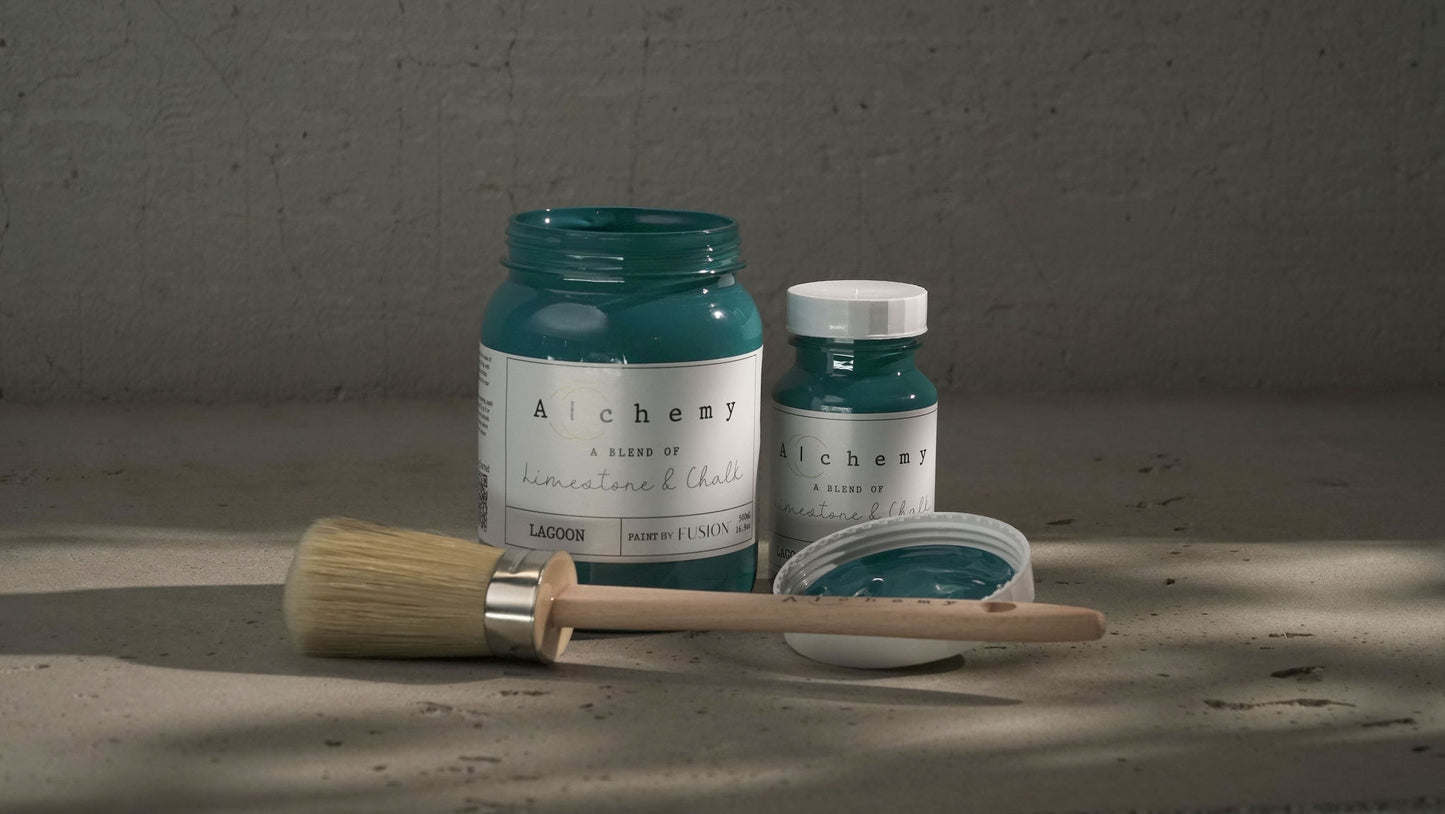 A jar of Alchemy by Fusion chalk paint in a lagoon color, which is a blend of green and blue.