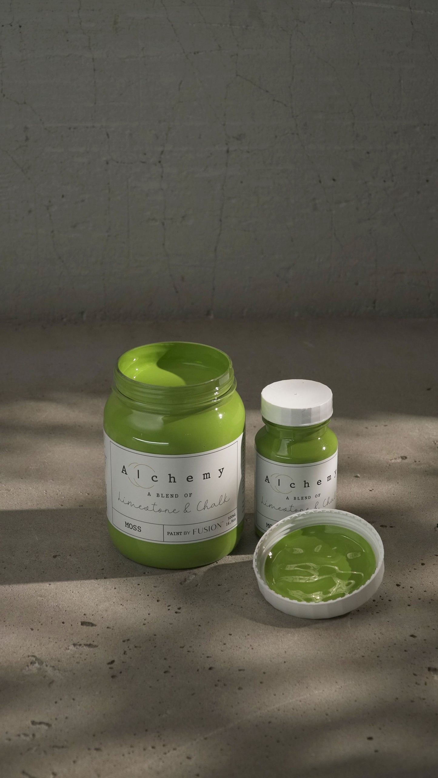 A jar of Alchemy by Fusion chalk paint in a chartreuse color, with a white label.