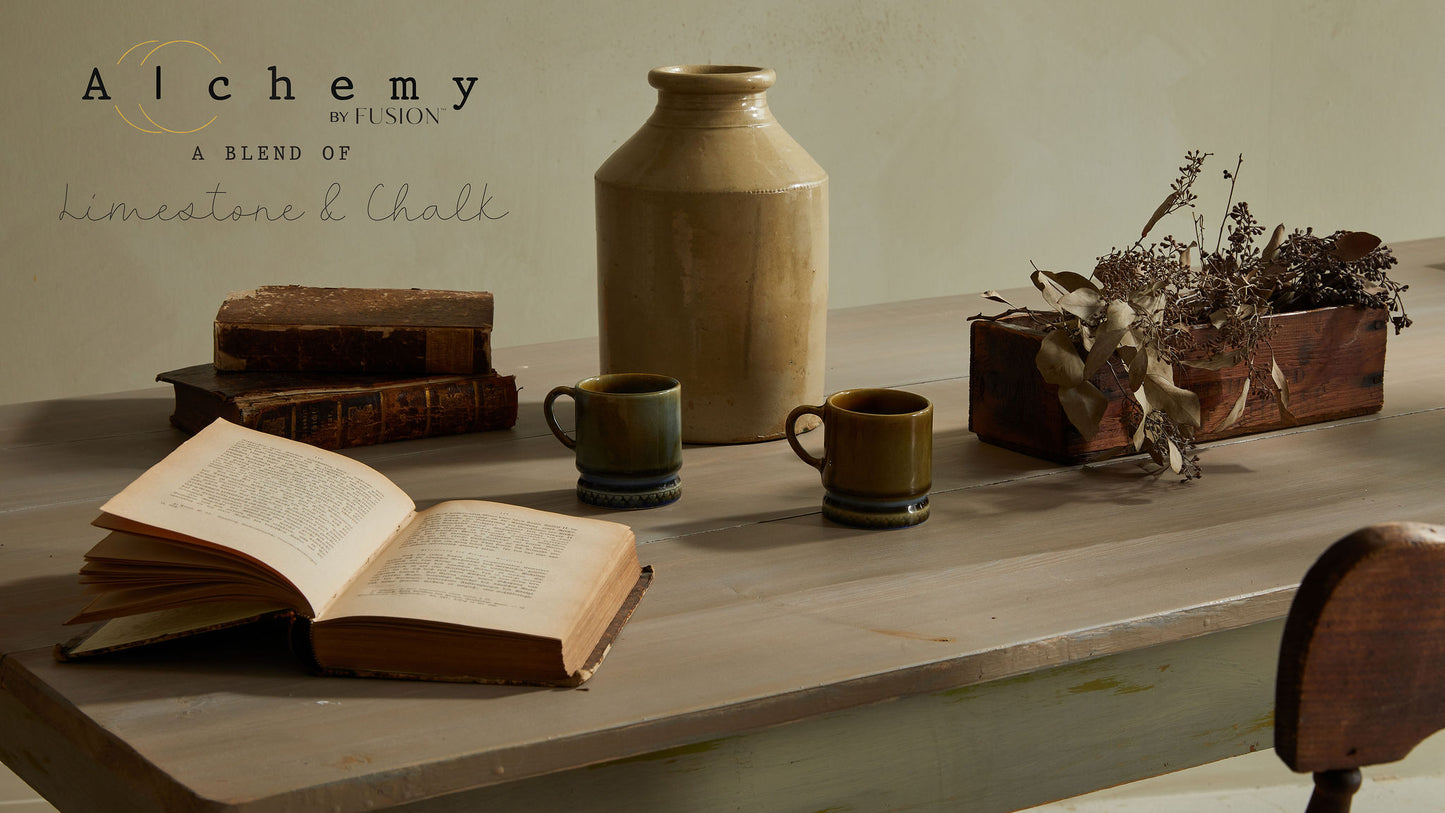A jar of Alchemy by Fusion chalk paint in a chartreuse color, with a white label.