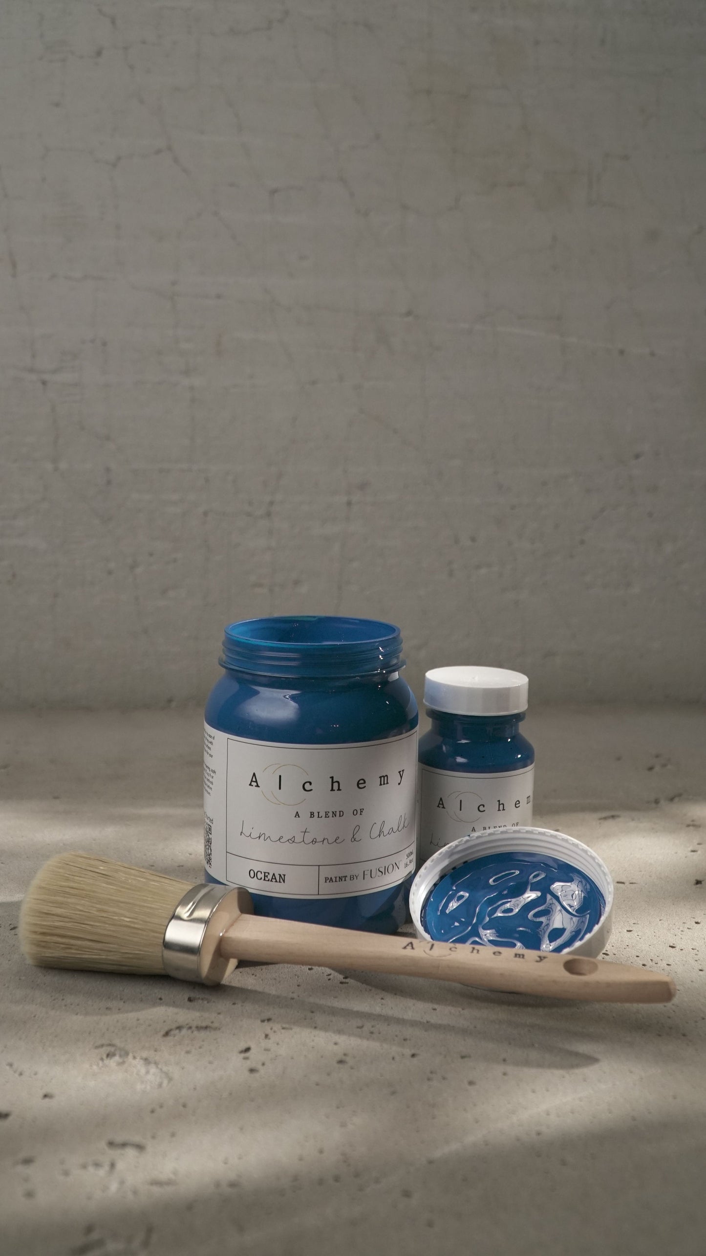 A jar of Alchemy by Fusion chalk paint in blue color, labeled Ocean.