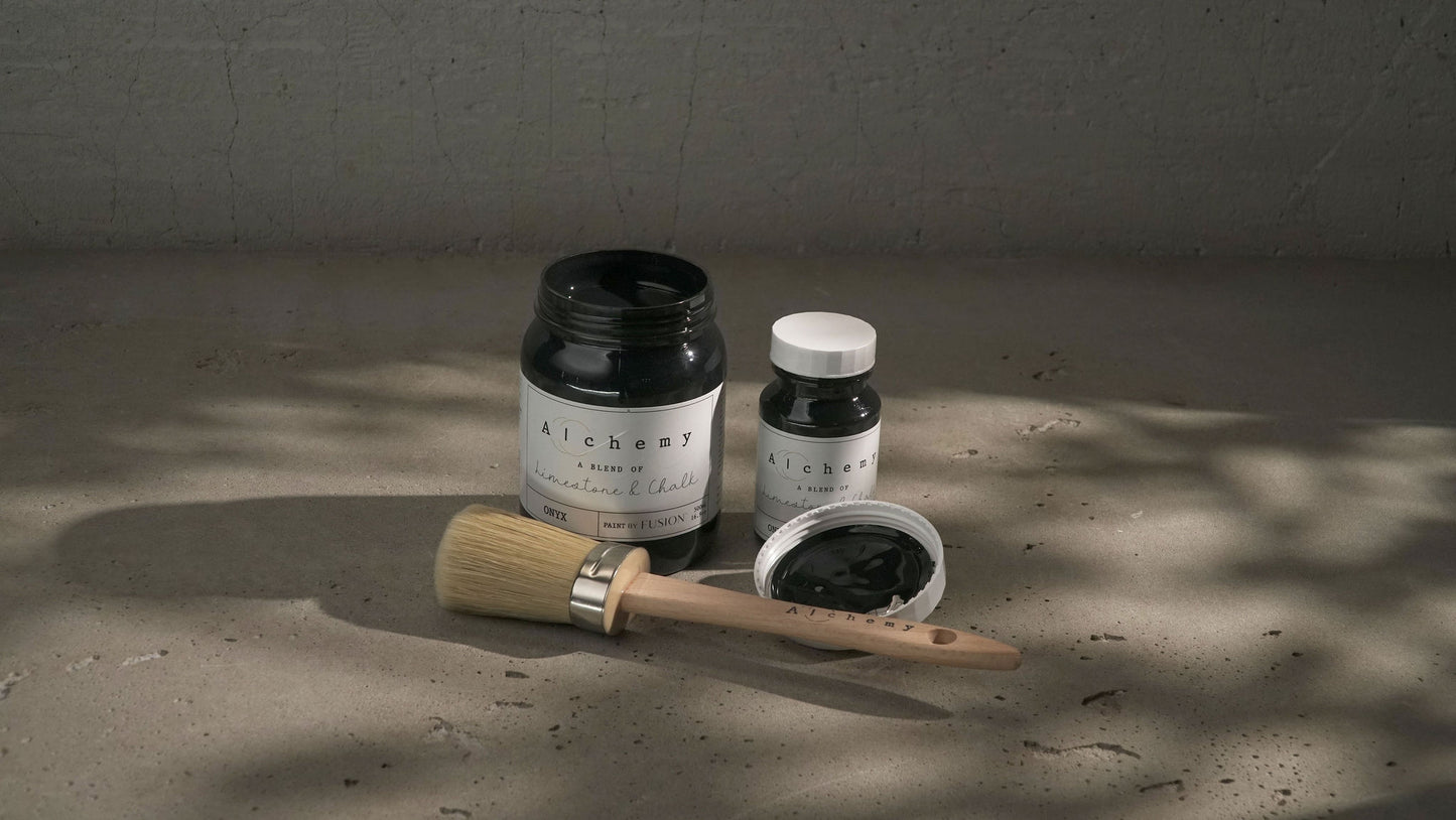 A jar of Alchemy by Fusion chalk paint in black color, with a white label.