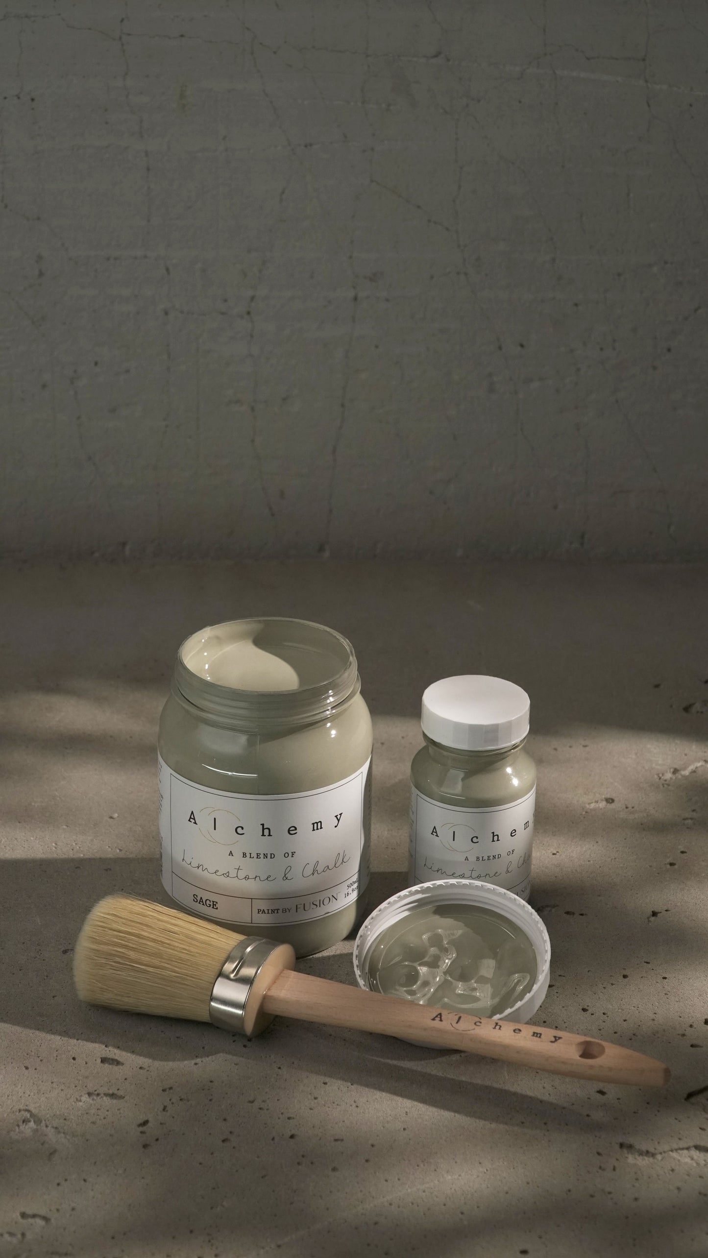 A jar of Alchemy by Fusion chalk paint in sage color, with a white label on the front.