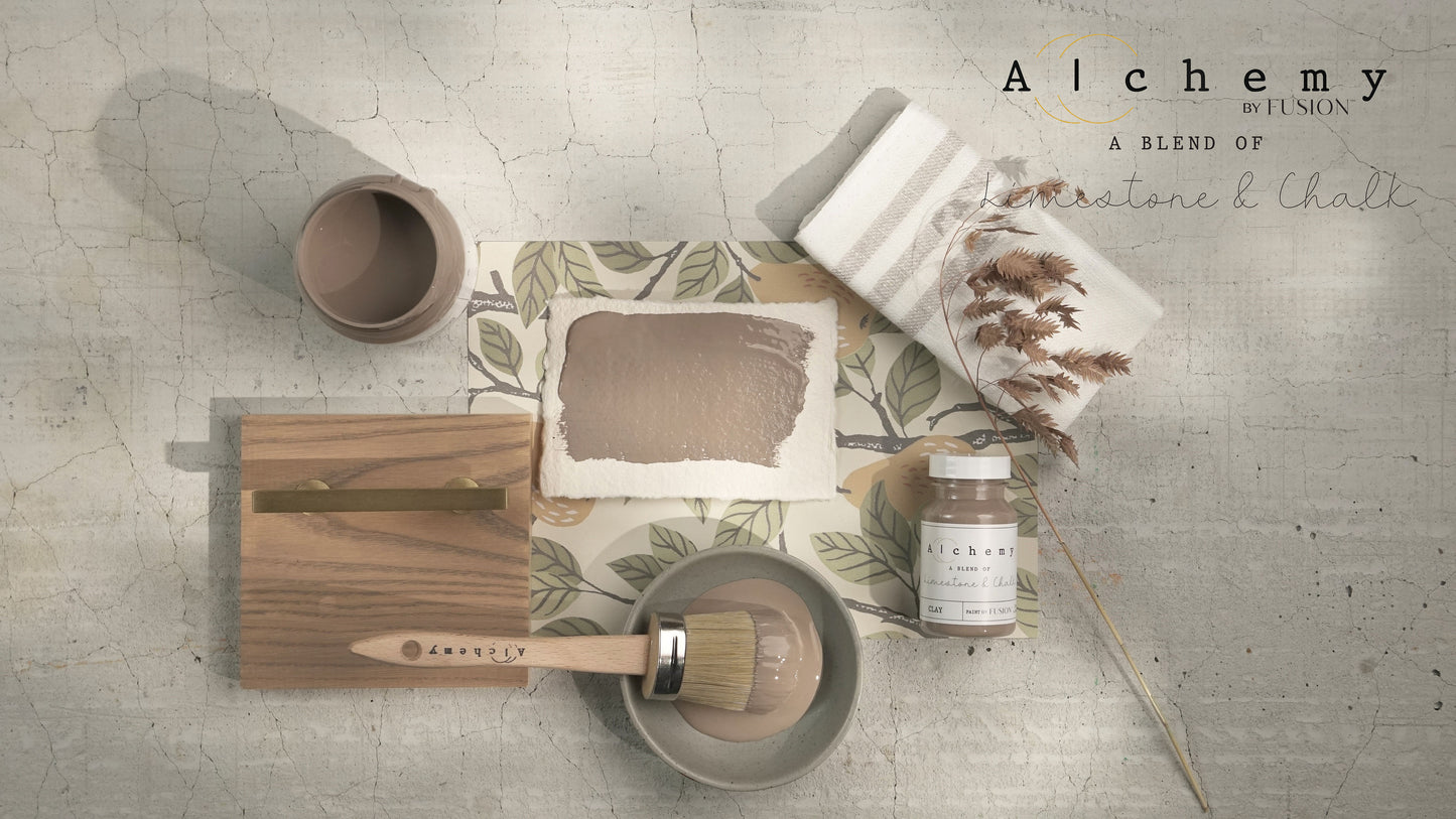 A jar of Alchemy by Fusion Clay paint in a deep taupe color with warm, grey tones.