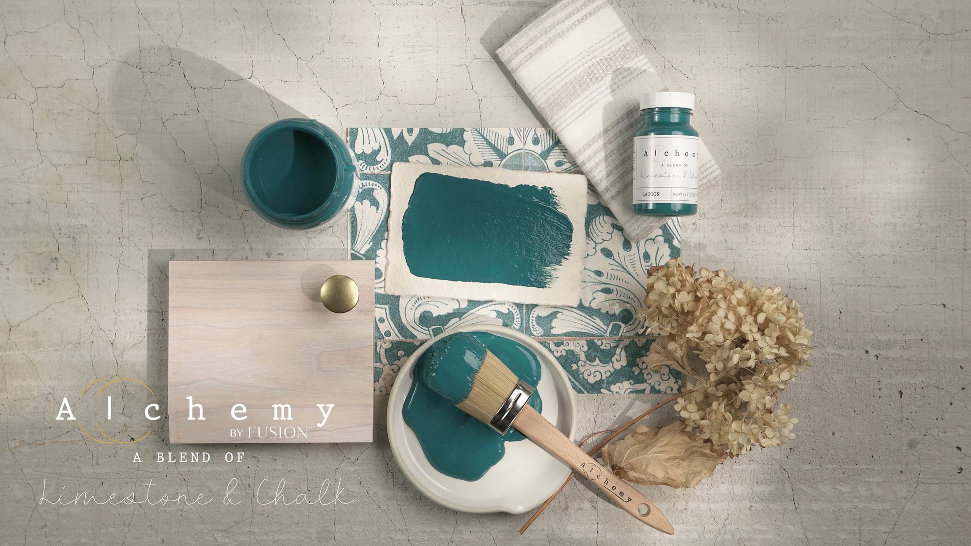 A jar of Alchemy by Fusion chalk paint in a lagoon color, which is a blend of green and blue.