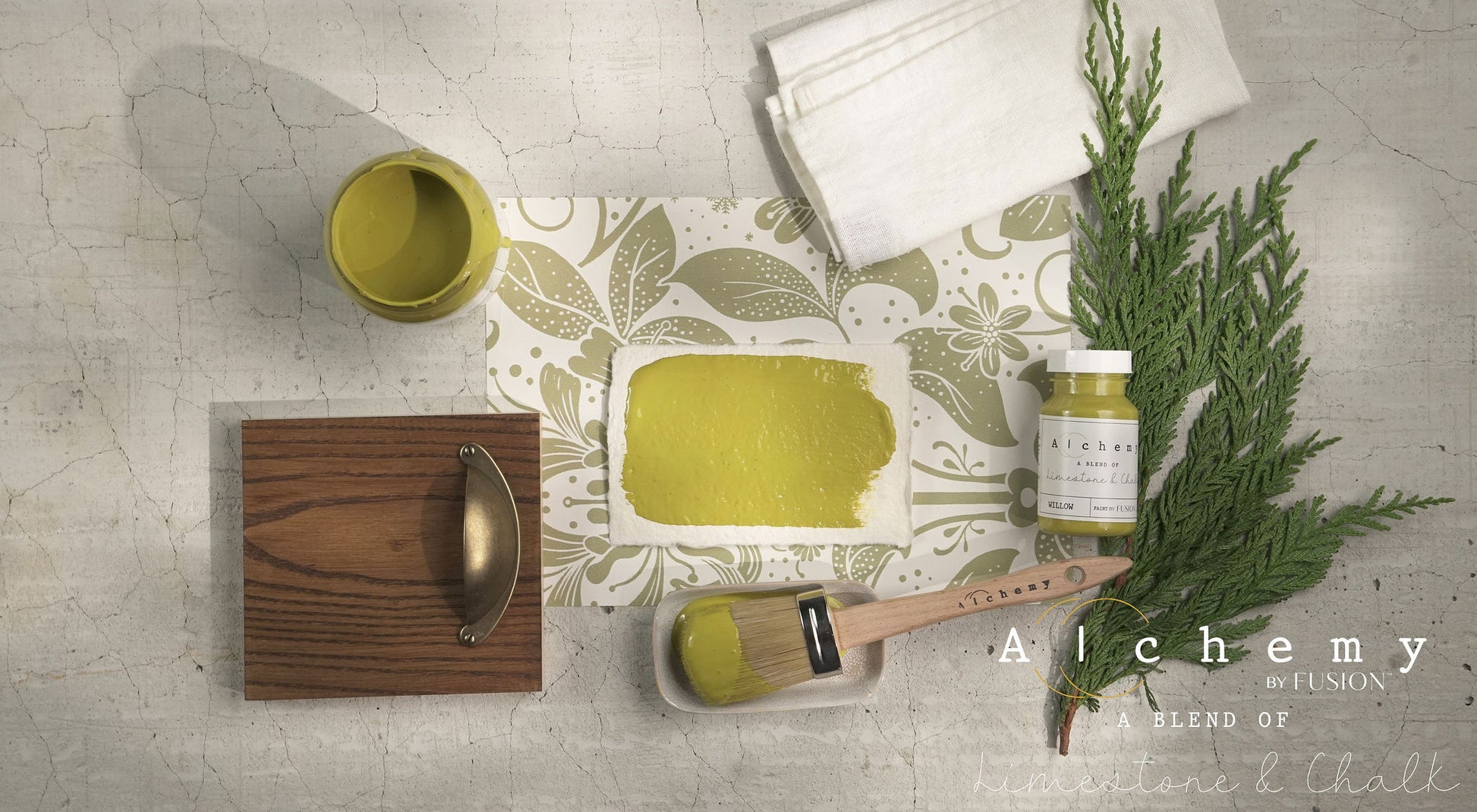 A jar of Alchemy by Fusion chalk paint in the color 'Willow', displaying the product label with white text on a yellow background.