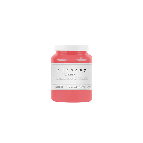 A jar of Alchemy by Fusion chalk paint in a vibrant coral color, labeled with the brand and product name.