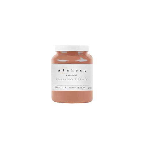 A jar of Alchemy by Fusion chalk paint in a terracotta color, labeled with the brand and product name.