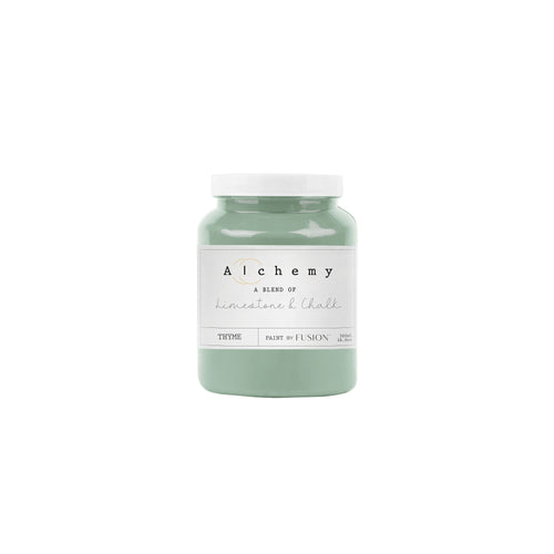 A jar of Alchemy by Fusion chalk paint in a thyme green color, with a white lid and a label that includes the product name and the color 'Thyme'.
