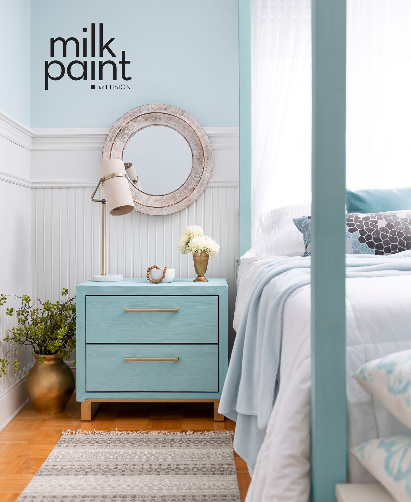 Bedroom with teal nightstand, mirror, and bed, featuring Fusion Milk Paint branding.