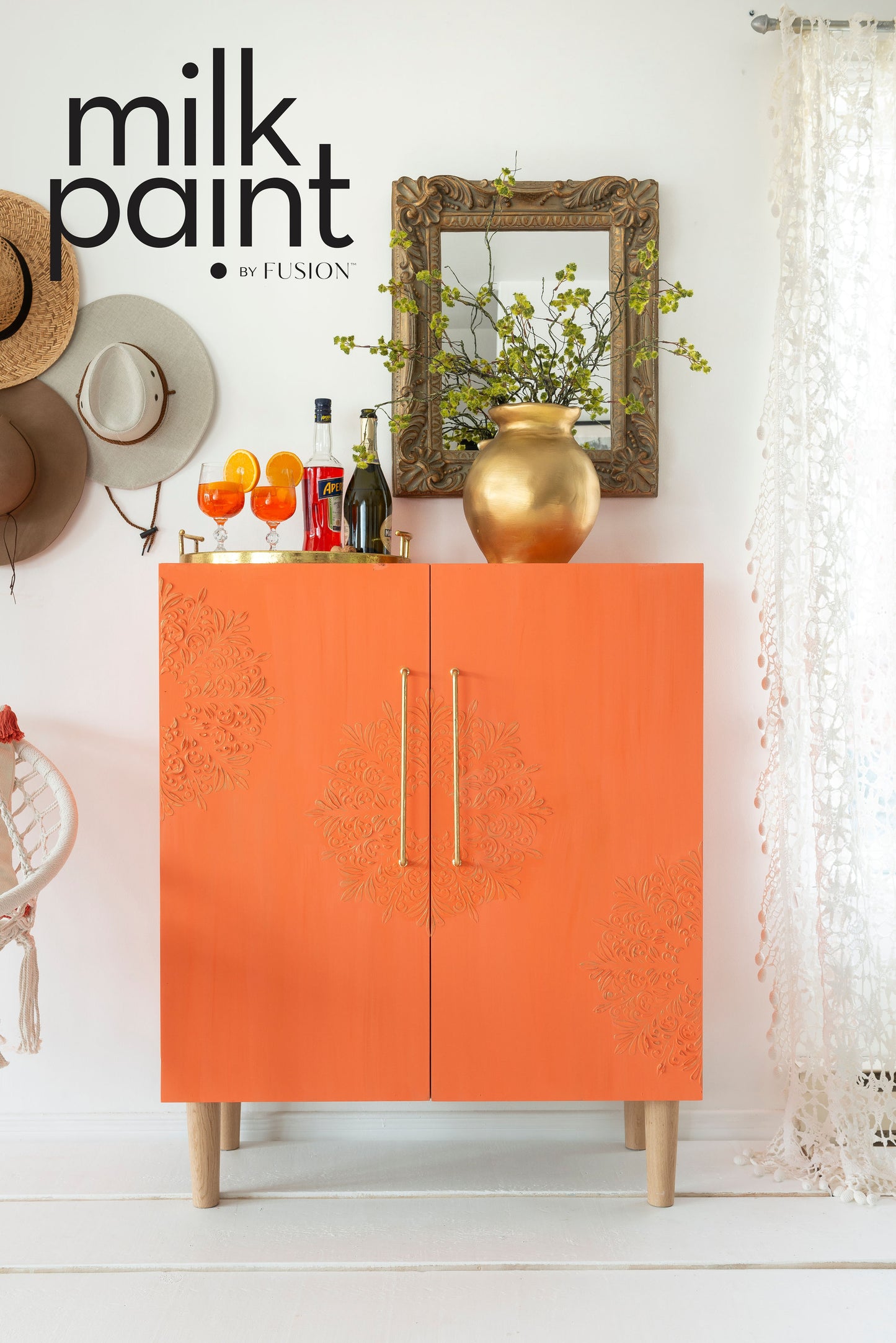 Orange cabinet with decorative elements in a home setting, featuring Fusion Milk Paint branding.