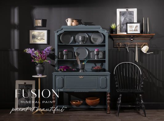 Room interior with dark gray cabinet, black chair, and Fusion Mineral Paint branding.