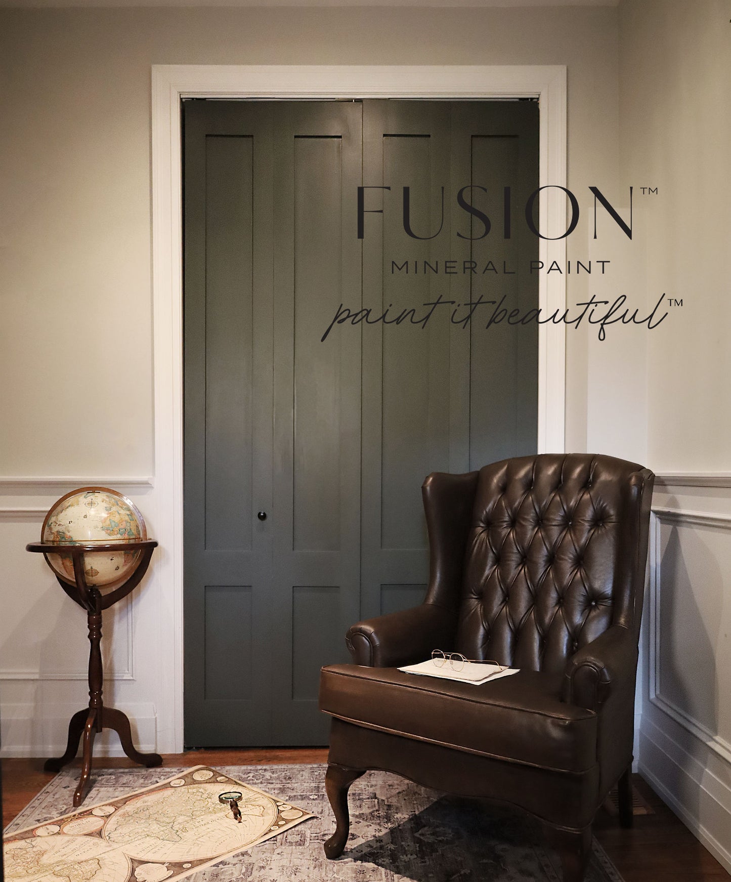 Room with a dark green door, brown leather chair, and vintage globe, featuring Fusion Mineral Paint branding.