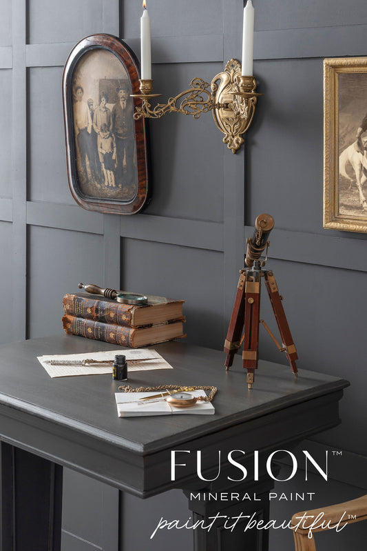 Gray wall with decorative items and Fusion Mineral Paint logo