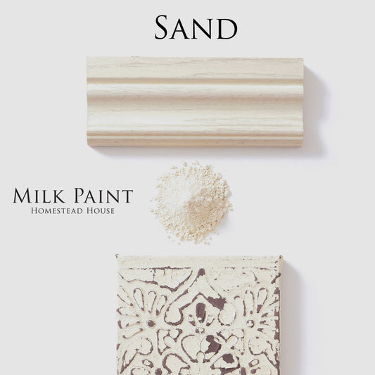 Sand-colored milk paint sample with a brush stroke and powder on a white background, featuring 'Homestead House' branding.