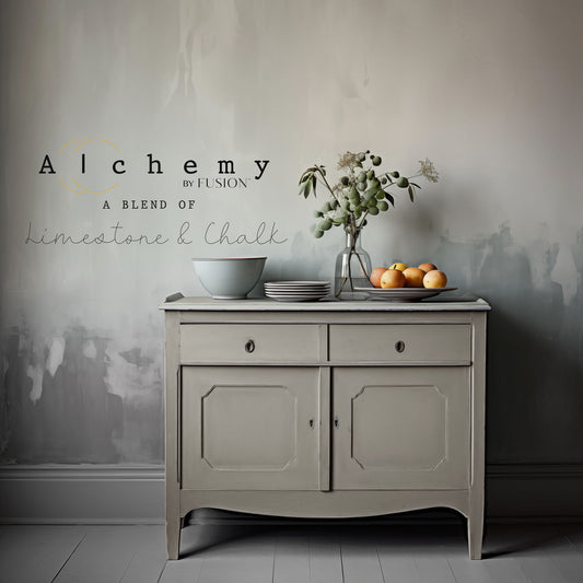A jar of Alchemy by Fusion chalk paint in a gray color, with a label that includes the product name and the brand's logo.