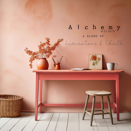 A jar of Alchemy by Fusion chalk paint in a vibrant coral color, labeled with the brand and product name.