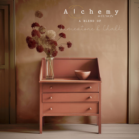 A jar of Alchemy by Fusion chalk paint in a terracotta color, labeled with the brand and product name.