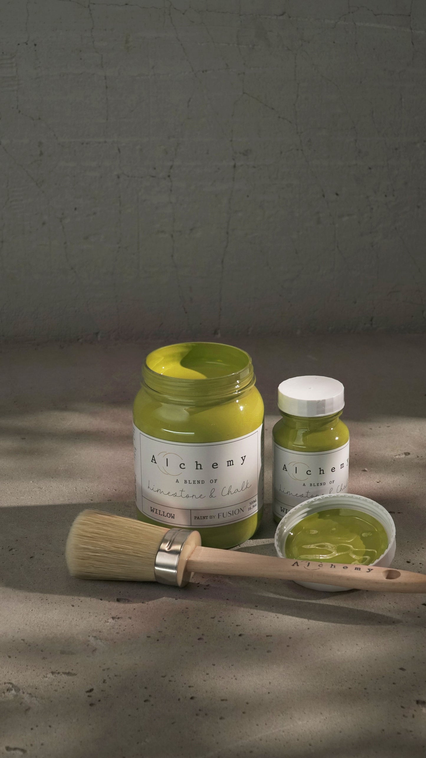 A jar of Alchemy by Fusion chalk paint in the color 'Willow', displaying the product label with white text on a yellow background.