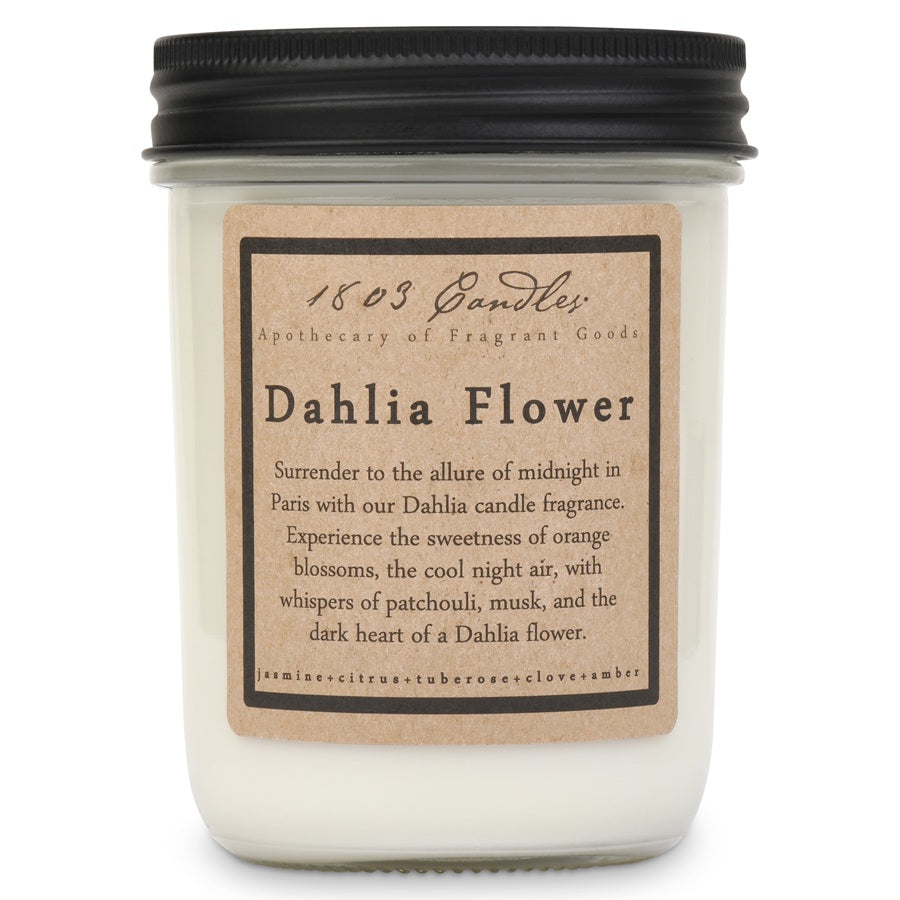 Candle with a label describing the fragrance and ingredients on a white background