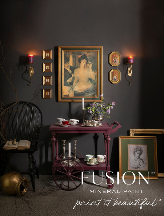 Dark room with vintage decor, including a framed painting and Fusion Mineral Paint logo.